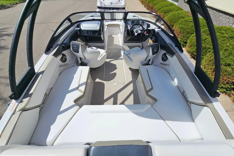 Slide: The Image of 2014 Scarab 215 boat interior with sleek seating and modern dashboard design. - 7