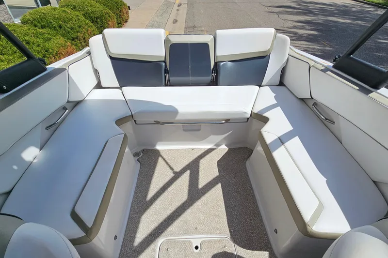 Slide: The Image of Interior of a 2014 Scarab 215 boat with white seating and gray accents. - 9