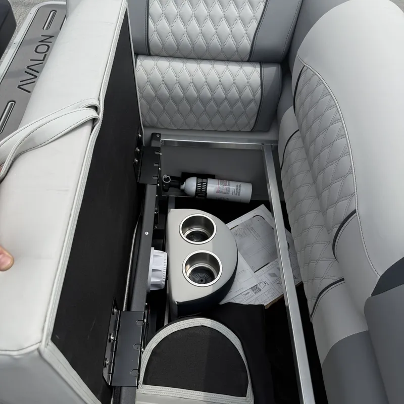 Slide: The Image of Interior of 2026 Avalon QLS25T Excalibur with storage and cup holders. - 19