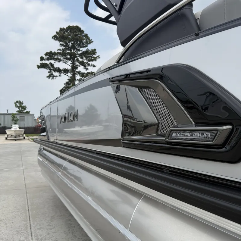 Slide: The Image of 2026 Avalon QLS25T Excalibur boat, side view with logo. - 33