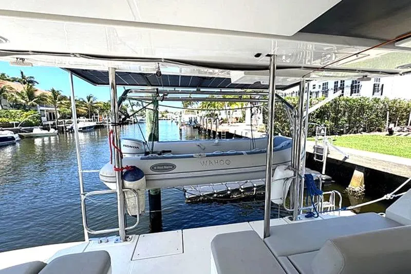 Slide: The Image of Leopard 50 yacht with dinghy, docked in a sunny marina, 2020 model. - 10
