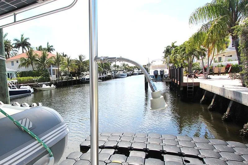 Slide: The Image of Canal view from Leopard 50 yacht, featuring docked boats and palm trees, 2020 model. - 12