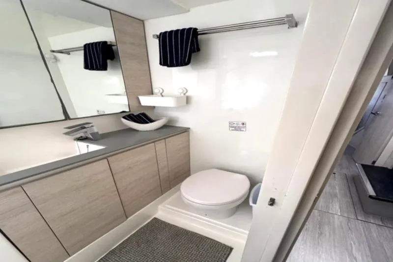 Slide: The Image of Modern bathroom in a 2020 Leopard 50 yacht, featuring sleek fixtures and ample storage. - 24