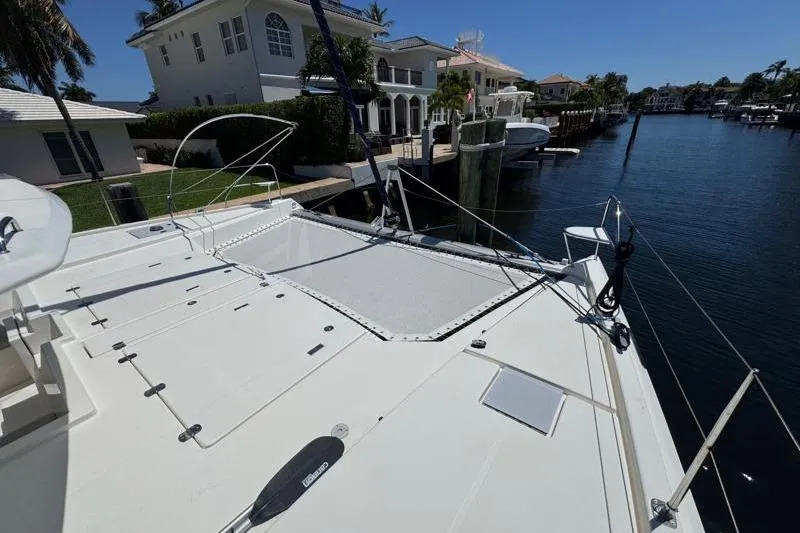 Slide: The Image of 2020 Leopard 50 yacht docked by waterfront homes, sunny day, calm water. - 29