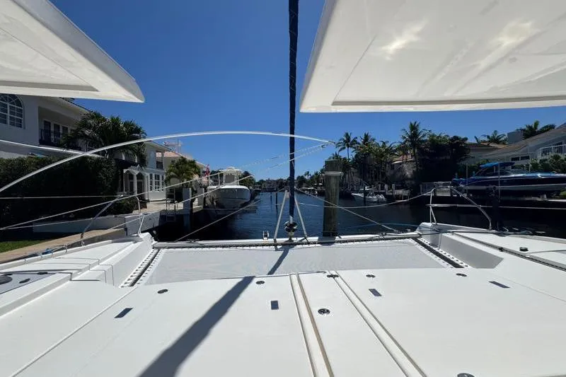 Slide: The Image of 2020 Leopard 50 catamaran docked in a sunny marina with palm trees. - 30