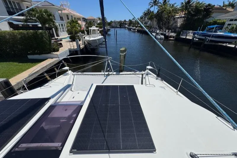 Slide: The Image of 2020 Leopard 50 yacht with solar panels docked in a scenic canal. - 31