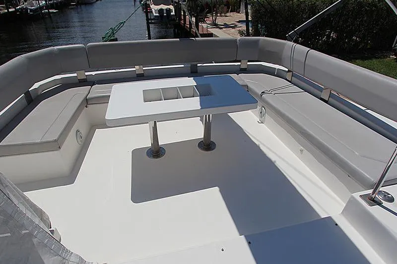 Slide: The Image of Spacious seating area on a 2020 Leopard 50 yacht, featuring a central table and waterfront view. - 35