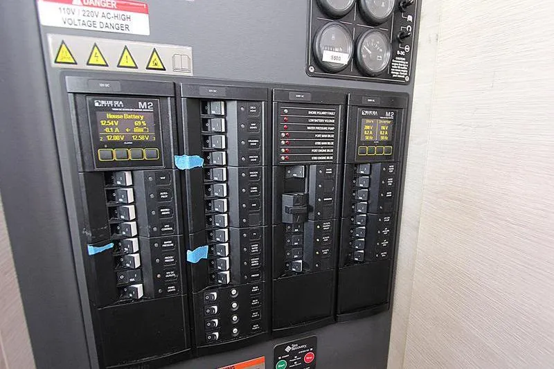 Slide: The Image of Electrical control panel in a 2020 Leopard 50, featuring circuit breakers and battery monitors. - 38