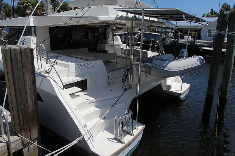 Slide: The Image of 2020 Leopard 50 yacht docked with dinghy, featuring spacious deck and modern design. - 5