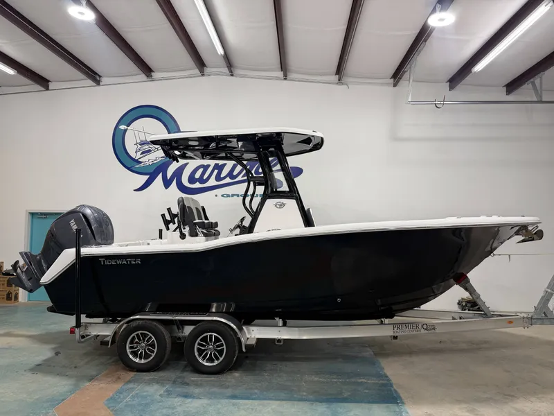 The Image of 2026 Tidewater 232 CC Adventure boat in a warehouse on a trailer. - 1