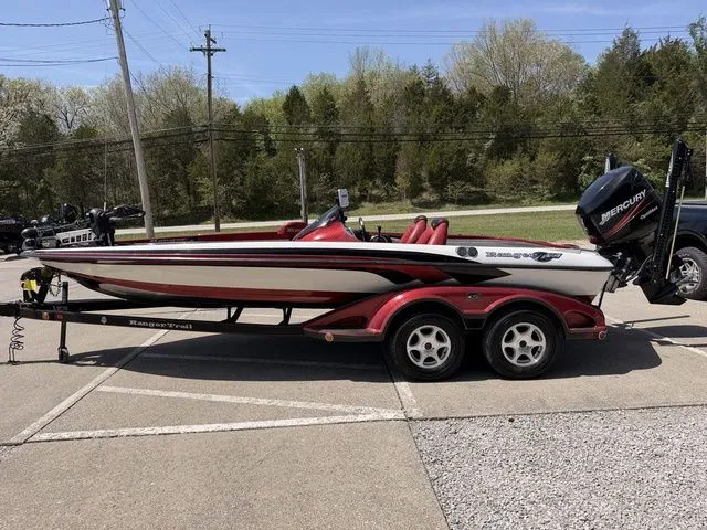 Slide: The Image of 2026 Ranger Z20 boat on trailer, red and white, parked outdoors. - 16