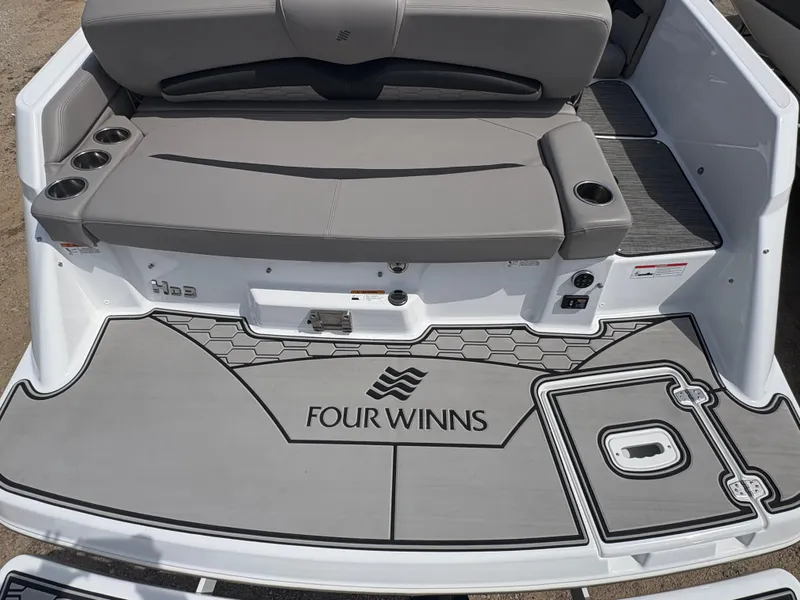 Slide: The Image of 2023 Four Winns HD3 boat rear with gray seating and logo. - 5