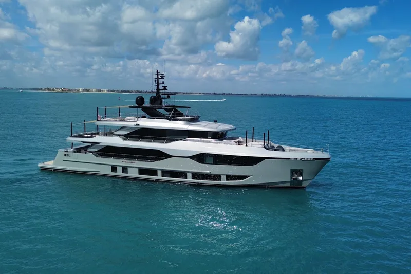 Slide: The Image of Luxury Majesty 120 yacht cruising on blue ocean under a partly cloudy sky, 2025 model. - 4