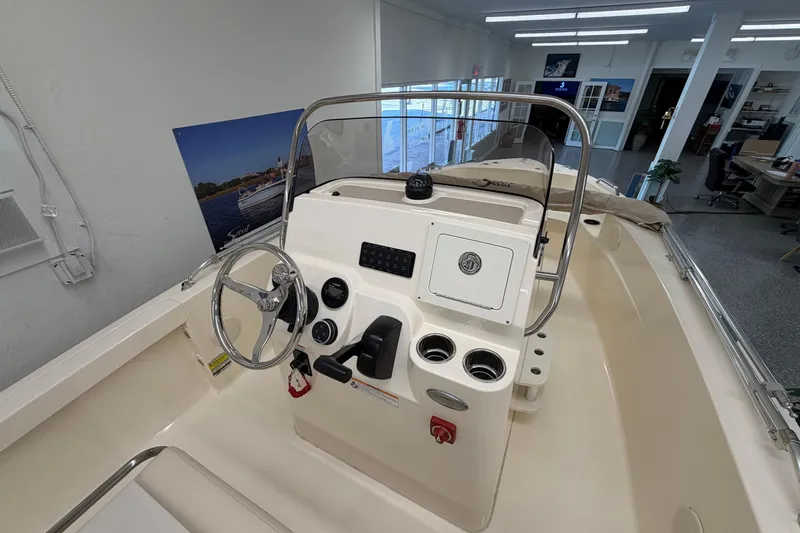 Slide: The Image of 2026 Scout 188 Sportfish boat interior with steering wheel and control panel. - 5