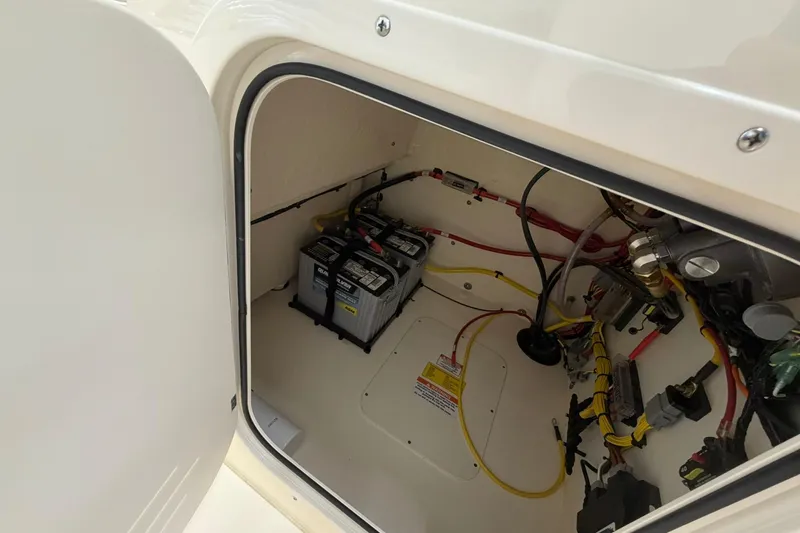 Slide: The Image of Battery compartment of 2026 Scout 188 Sportfish boat with wiring and components. - 7