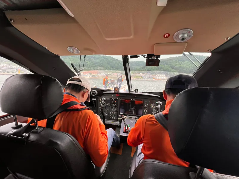Slide: The Image of Cockpit view of Aron M 80 helicopter, 2025 model, with two pilots in orange uniforms. - 23
