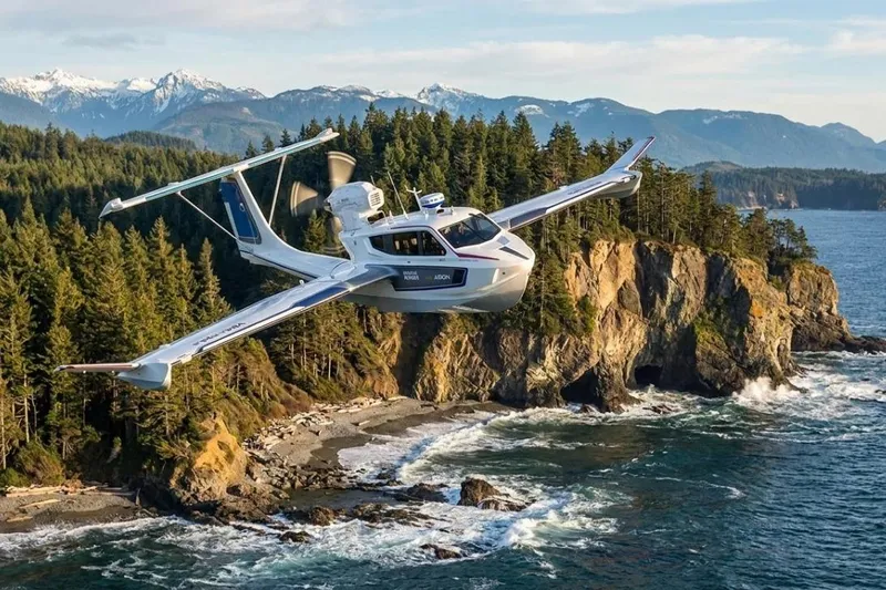 Slide: The Image of Futuristic Aron M 80 seaplane flying over scenic coastal cliffs, 2026 model. - 5