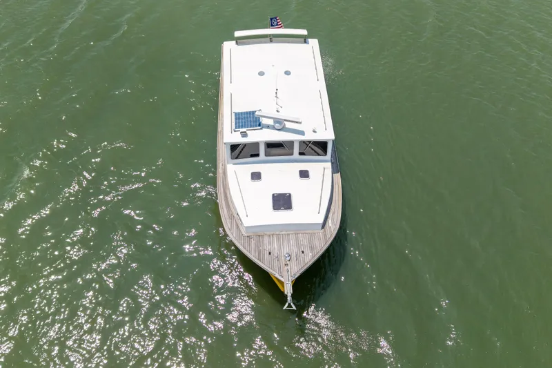 Slide: The Image of Overhead view of 2001 Redfern Mitchell Cove 32 boat on green water. - 12