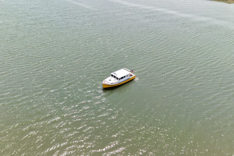 Slide: The Image of Aerial view of 2001 Redfern Mitchell Cove 32 boat on calm water. - 13