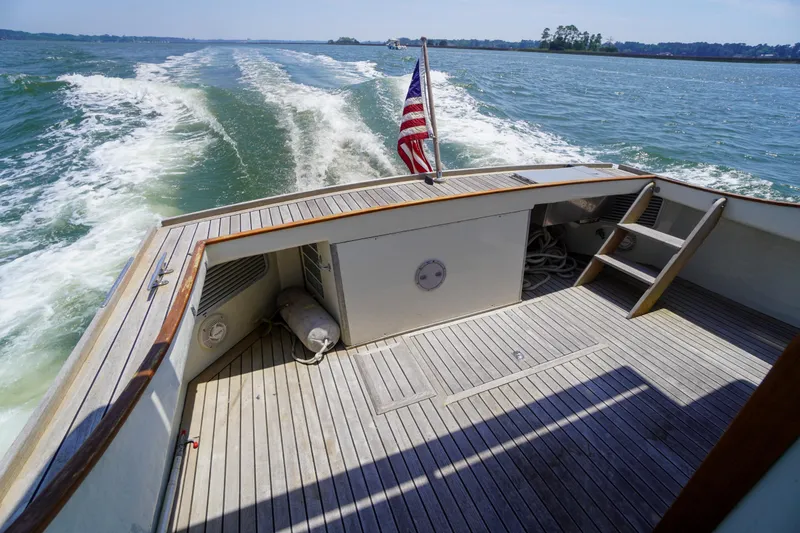 Slide: The Image of Redfern Mitchell Cove 32 boat cruising on open water, rear deck view, 2001 model. - 15