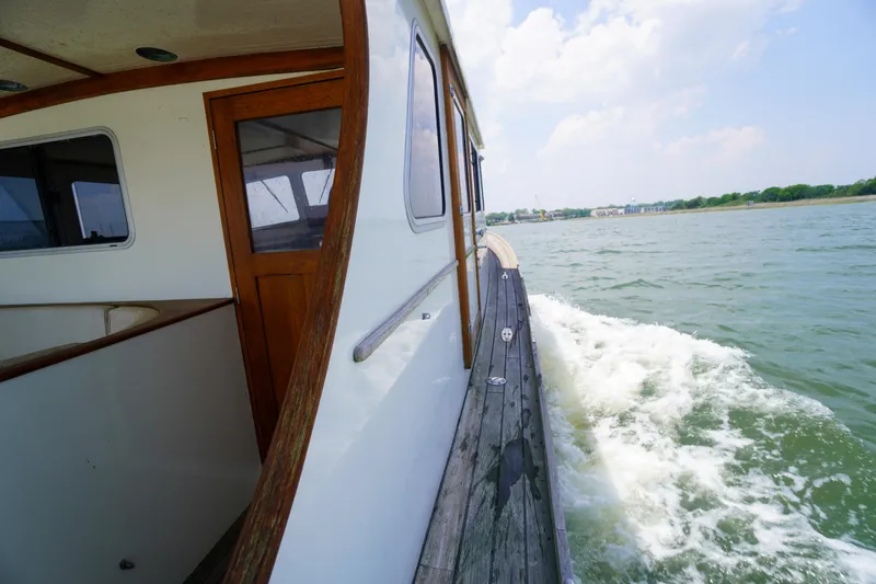 Slide: The Image of 2001 Redfern Mitchell Cove 32 cruising on a sunny day, wooden deck and cabin visible. - 19