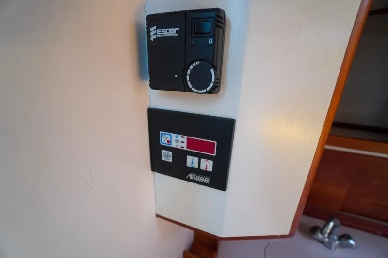 Slide: The Image of Control panel inside a 2001 Redfern Mitchell Cove 32 boat, featuring heating and ventilation systems. - 24