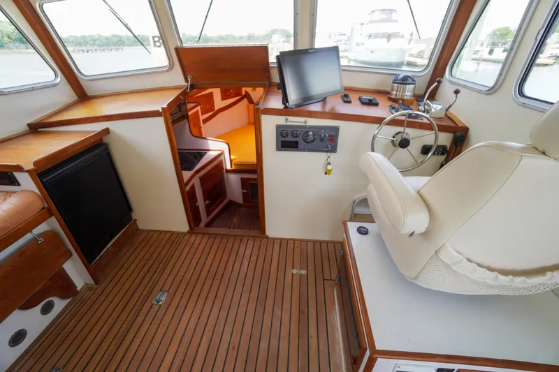 Slide: The Image of Interior of 2001 Redfern Mitchell Cove 32 boat with helm, seating, and navigation equipment. - 42
