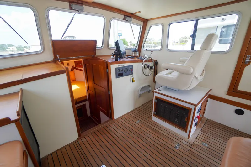 Slide: The Image of Interior of 2001 Redfern Mitchell Cove 32 boat with helm and seating area. - 43