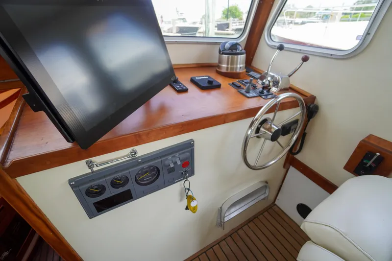 Slide: The Image of Interior helm of 2001 Redfern Mitchell Cove 32 boat with steering wheel and controls. - 45