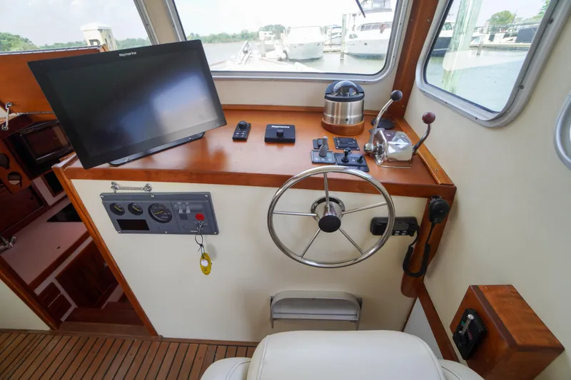 Slide: The Image of Interior helm of 2001 Redfern Mitchell Cove 32 with steering wheel and navigation equipment. - 46