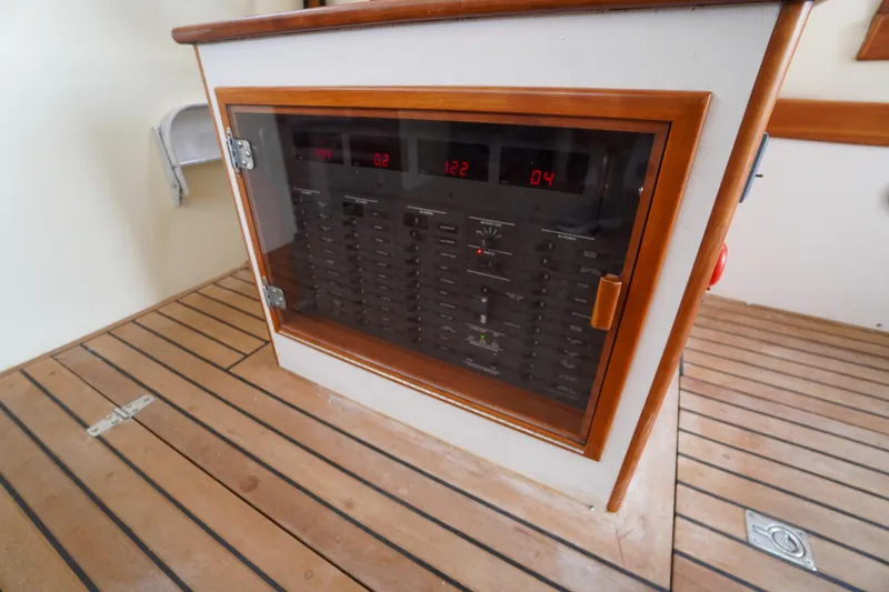 Slide: The Image of Electrical panel on 2001 Redfern Mitchell Cove 32 boat with wooden trim and digital displays. - 51