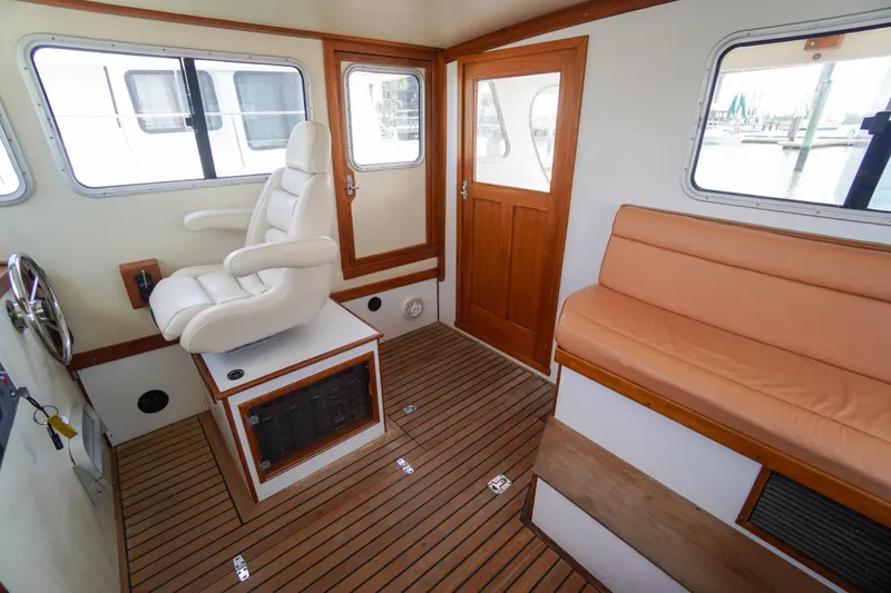 Slide: The Image of Interior of 2001 Redfern Mitchell Cove 32 boat with seating and helm. - 54