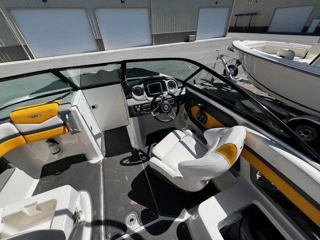 Slide: The Image of Interior of a 2015 Chaparral Vortex 223 VRX boat with yellow accents. - 10