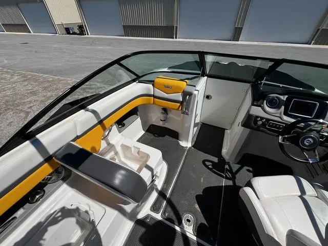 Slide: The Image of Interior of a 2015 Chaparral Vortex 223 VRX boat with yellow accents. - 21