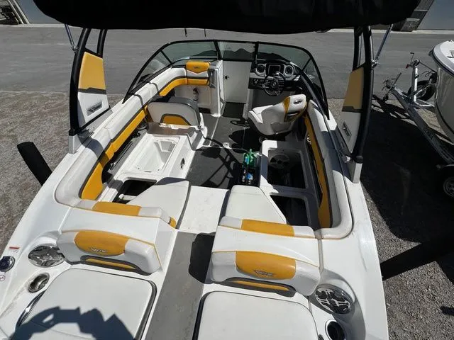 Slide: The Image of Interior view of a 2015 Chaparral Vortex 223 VRX boat with yellow accents. - 8