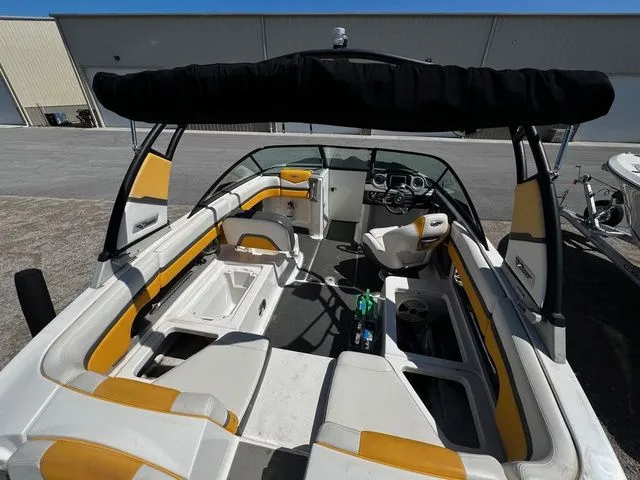 Slide: The Image of Interior view of a 2015 Chaparral Vortex 223 VRX boat with yellow accents. - 9