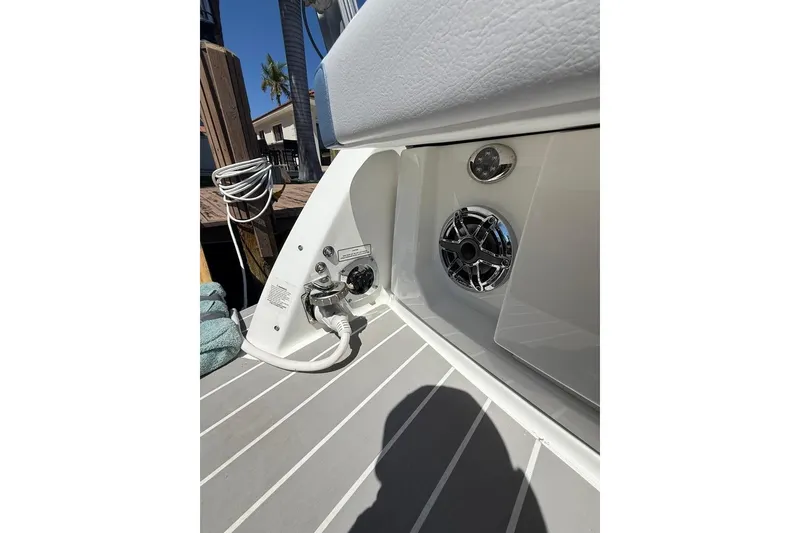 Slide: The Image of 2025 Formula 330 Crossover Bowrider OB boat deck with speaker and power outlet. - 10