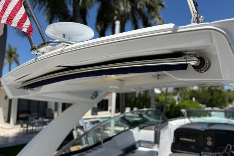 Slide: The Image of 2025 Formula 330 Crossover Bowrider OB boat with sleek design and American flag. - 19