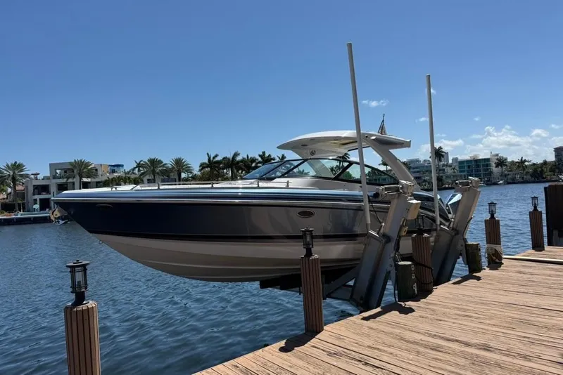 Slide: The Image of 2025 Formula 330 Crossover Bowrider OB on dock, sunny waterfront view. - 3