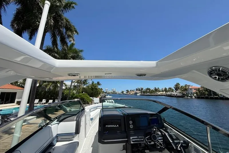 Slide: The Image of 2025 Formula 330 Crossover Bowrider OB interior with open storage compartment. - 30