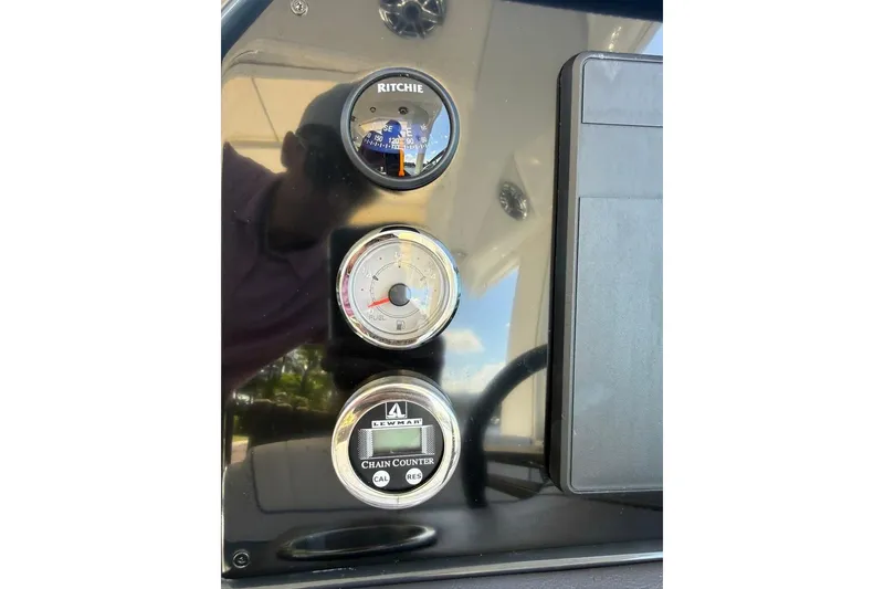 Slide: The Image of Storage compartment in 2025 Formula 330 Crossover Bowrider OB with pool noodles and gear. - 43