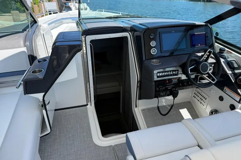 Slide: The Image of 2025 Formula 330 Crossover Bowrider OB storage compartment with cup holders and accessories. - 44