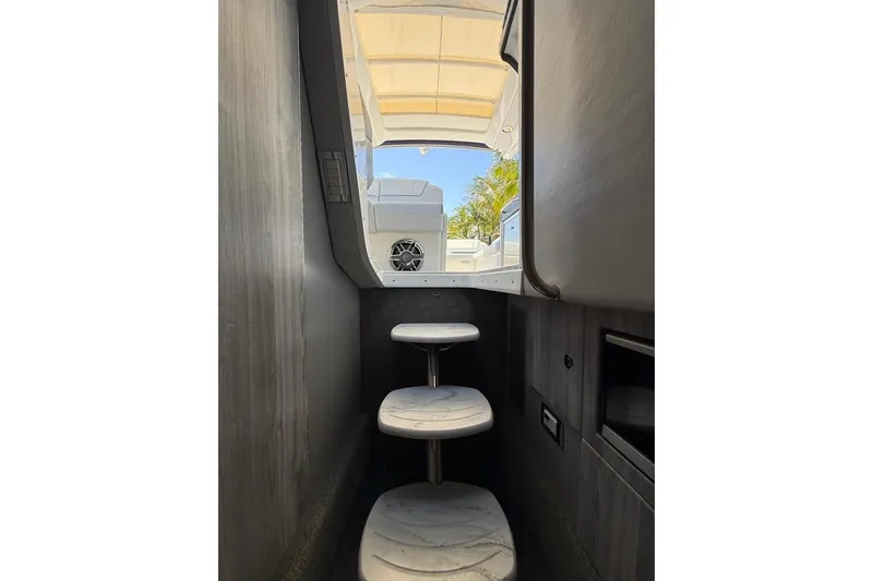 Slide: The Image of 2025 Formula 330 Crossover Bowrider OB cockpit with modern controls and lake view. - 46