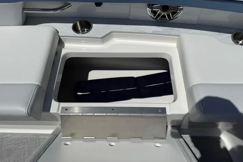 Slide: The Image of 2025 Formula 330 Crossover Bowrider OB storage compartment with cushioned seating and cup holder. - 61