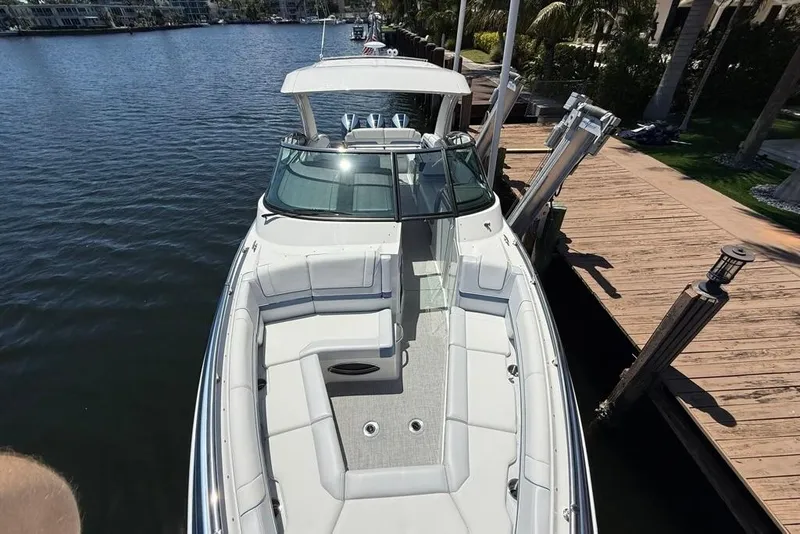 Slide: The Image of 2025 Formula 330 Crossover Bowrider OB docked by a wooden pier. - 65