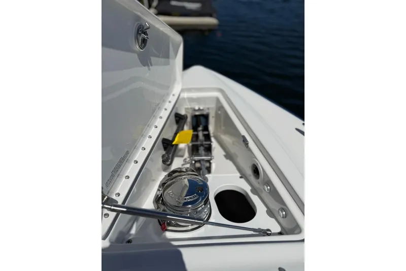 Slide: The Image of 2025 Formula 330 Crossover Bowrider OB anchor compartment detail on water. - 69