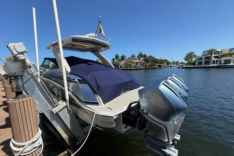Slide: The Image of 2025 Formula 330 Crossover Bowrider OB docked with triple outboard engines. - 72