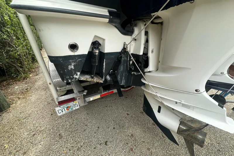 Slide: The Image of 2004 Boston Whaler 270 Outrage on trailer, showing rear view and outboard motor. - 12