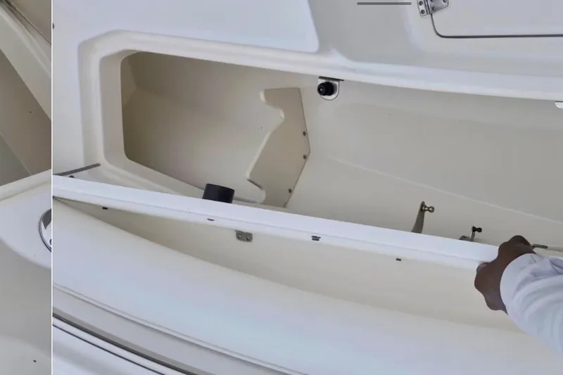 Slide: The Image of Open storage compartment on a 2004 Boston Whaler 270 Outrage boat. - 21