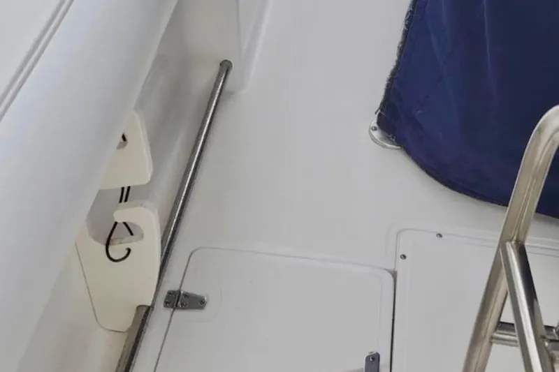 Slide: The Image of Interior view of a 2004 Boston Whaler 270 Outrage boat, featuring a metal railing. - 22